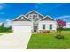 Charming single-story home featuring a white siding, stone accents, and a well-manicured lawn at 240 Wagner Cir., Conway, SC 29526