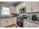 Well-lit kitchen featuring granite countertops, stainless steel appliances, and white cabinetry at 240 Wagner Cir., Conway, SC 29526