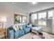 Bright living room boasts a blue sofa, decorative pillows, and large window with view at 240 Wagner Cir., Conway, SC 29526