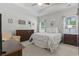 Bright bedroom with ceiling fan, tray ceilings, and queen bed in neutral decor at 2405 Capri Court, Conway, SC 29527
