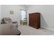 Bedroom with comfortable gray recliner, wooden chair, and large wooden wardrobe at 2405 Capri Court, Conway, SC 29527