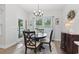 Bright dining area featuring modern chandelier, round table and outdoor access at 2405 Capri Court, Conway, SC 29527