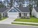Charming single-Gathering home with a well-manicured lawn, attached garage, and eye-catching blue accent features at 2405 Capri Court, Conway, SC 29527