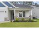Inviting front porch with brick accents, manicured landscaping, and a charming entryway at 2405 Capri Court, Conway, SC 29527