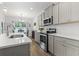 Bright kitchen featuring gray cabinetry, stainless steel appliances, and a subway tile backsplash at 2405 Capri Court, Conway, SC 29527