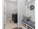 Mud room featuring a laundry room with dark washer and dryer and decorative accents above the padded bench at 2405 Capri Court, Conway, SC 29527