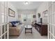Cozy living room with sofa, glass coffee table, mounted TV, and bright windows at 2405 Capri Court, Conway, SC 29527