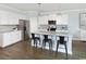Modern kitchen featuring stainless steel appliances, white cabinets, and a kitchen island with barstool seating at 2429 Watershed Way, Longs, SC 29568
