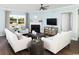 Bright living room boasts a fireplace, hardwood floors, neutral paint, and large windows for natural light at 2429 Watershed Way, Longs, SC 29568
