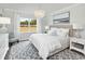 Serene primary bedroom with a large window, soft natural light, neutral decor, and stylish furnishings at 2429 Watershed Way, Longs, SC 29568