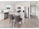 Modern kitchen featuring stainless steel appliances, white cabinets, granite countertops, and a kitchen island at 2500 Watershed Way, Longs, SC 29568