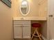 Bright bathroom featuring white cabinetry, oval mirror, and a comfortable red cushioned stool at 2507 S Ocean Blvd., North Myrtle Beach, SC 29582
