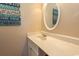 Bright bathroom with a round mirror above a vanity, adorned with coastal decor at 2507 S Ocean Blvd., North Myrtle Beach, SC 29582
