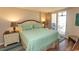 Serene bedroom with a plush queen bed, sliding glass door, and calming coastal decor at 2507 S Ocean Blvd., North Myrtle Beach, SC 29582