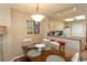 Cozy dining area with a wooden table, white chairs, and adjacent breakfast bar at 2507 S Ocean Blvd., North Myrtle Beach, SC 29582