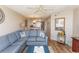 Inviting living room featuring a comfortable blue sofa, wood flooring, and open layout to dining area at 2507 S Ocean Blvd., North Myrtle Beach, SC 29582