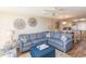 Living room featuring a sectional sofa and an ottoman, with the kitchen visible in the background at 2507 S Ocean Blvd., North Myrtle Beach, SC 29582