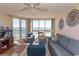 Living room featuring comfortable seating and ocean views from the sliding glass doors and windows at 2507 S Ocean Blvd., North Myrtle Beach, SC 29582