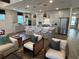 Open-concept kitchen with large island, stainless steel appliances, pendant lighting, and hardwood floors at 2521 Watershed Way, Longs, SC 29568