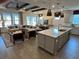 Open-concept living room featuring hardwood floors, large windows, comfortable seating, and modern decor at 2521 Watershed Way, Longs, SC 29568
