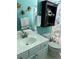 Bathroom with turquoise walls, white vanity, decorative fish accents, and mermaid statue at 3012 Winding River Rd., North Myrtle Beach, SC 29582