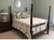 Cozy bedroom featuring a four-poster bed with tropical patterned bedding and a side table at 3012 Winding River Rd., North Myrtle Beach, SC 29582