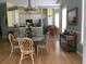 Open-concept dining area with glass-top table, wood floors and view of kitchen at 3012 Winding River Rd., North Myrtle Beach, SC 29582