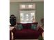 Open-concept living room with access to a sunroom, with stylish red sofas at 3012 Winding River Rd., North Myrtle Beach, SC 29582