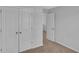Bedroom with neutral carpet and paint, featuring closet doors, base trim, and interior door at 36 Cape Point Dr., Conway, SC 29527