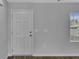 Bright entryway with a white paneled door, hardwood floors, and a window at 36 Cape Point Dr., Conway, SC 29527