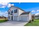 Side view of a charming two-story home showcasing the driveway and attached two car garage at 36 Cape Point Dr., Conway, SC 29527