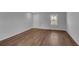 Bright, airy living room with laminate wood flooring, a window, and white painted walls at 36 Cape Point Dr., Conway, SC 29527