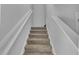 Carpeted staircase featuring white painted rails and neutral walls, leading to the upper level at 36 Cape Point Dr., Conway, SC 29527