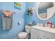 Bathroom featuring a round mirror, vanity, toilet and toiletries at 3700 Golf Colony Lane # 6J, Little River, SC 29566
