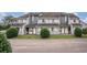 Neat townhouse complex with gray siding and well-maintained front entrances with white doors and windows at 3700 Golf Colony Lane # 6J, Little River, SC 29566