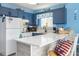 Bright kitchen with quartz countertops, white appliances, and nautical-themed decor for a coastal feel at 3700 Golf Colony Lane # 6J, Little River, SC 29566