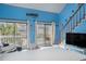 Bright living area with sliding glass doors to a balcony overlooking a pool and lush landscaping at 3700 Golf Colony Lane # 6J, Little River, SC 29566