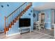 Living room with wood stairs, TV, and dining area creates a cozy and functional living space at 3700 Golf Colony Lane # 6J, Little River, SC 29566