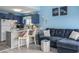 Cozy living space with blue walls, a sectional sofa, and an open kitchen with a breakfast bar at 3700 Golf Colony Lane # 6J, Little River, SC 29566