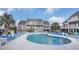 Lovely outdoor pool with surrounding lounge areas and seating, ideal for resort relaxation at 3700 Golf Colony Lane # 6J, Little River, SC 29566