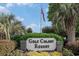 Welcoming 'Golf Colony Resort' sign surrounded by lush greenery and an American flag at 3700 Golf Colony Lane # 6J, Little River, SC 29566