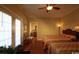 Cozy bedroom boasts two beds, bright windows, hardwood floors, and a ceiling fan for added comfort at 3709 N Ocean Blvd., North Myrtle Beach, SC 29582