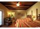 Bright bedroom with tropical ceiling and two beds featuring colorful striped bedding and a cozy wicker chair at 3709 N Ocean Blvd., North Myrtle Beach, SC 29582