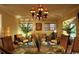 Elegant dining room features a round glass table, decorative chandelier, and plenty of natural light at 3709 N Ocean Blvd., North Myrtle Beach, SC 29582