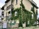 Multi-story home with a unique facade covered in lush greenery, offering a blend of nature and modern living at 3709 N Ocean Blvd., North Myrtle Beach, SC 29582