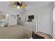 Cozy bedroom featuring a ceiling fan, light walls and wood look floors at 3795 Hitchcock Way # 618, Myrtle Beach, SC 29577