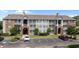 Low-angle shot of an apartment complex with brick and siding, showcasing well-maintained landscaping and ample parking at 3795 Hitchcock Way # 618, Myrtle Beach, SC 29577
