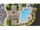 Aerial view of a community pool area featuring a pool, lounge seating, and surrounding green landscape at 3795 Hitchcock Way # 618, Myrtle Beach, SC 29577