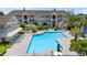 An aerial shot of a community pool with seating, palm trees, and lush landscaping at 3795 Hitchcock Way # 618, Myrtle Beach, SC 29577