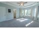 Large bedroom with tray ceiling, plush carpeting, and abundant natural light through multiple windows at 395 Dunbarton Ln., Conway, SC 29526